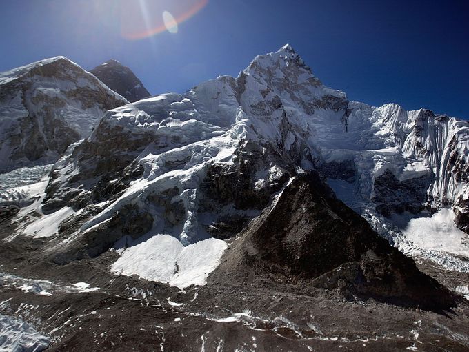 This aerial photograph of Mount Everest (back-center) and Everest's West Shoulder with Nuptse (right) May 15, 2003 on the Nepal - Tibet border.